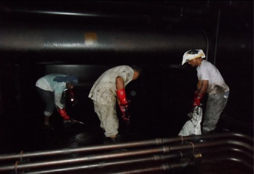 Men cleaning cargo tank. Men cleaning cargo tank.